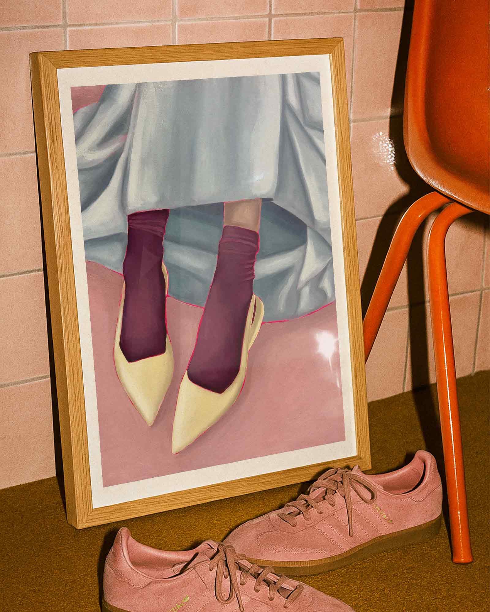 Framed art print of person wearing yellow shoes, maroon socks, and a light blue skirt on a pink background.