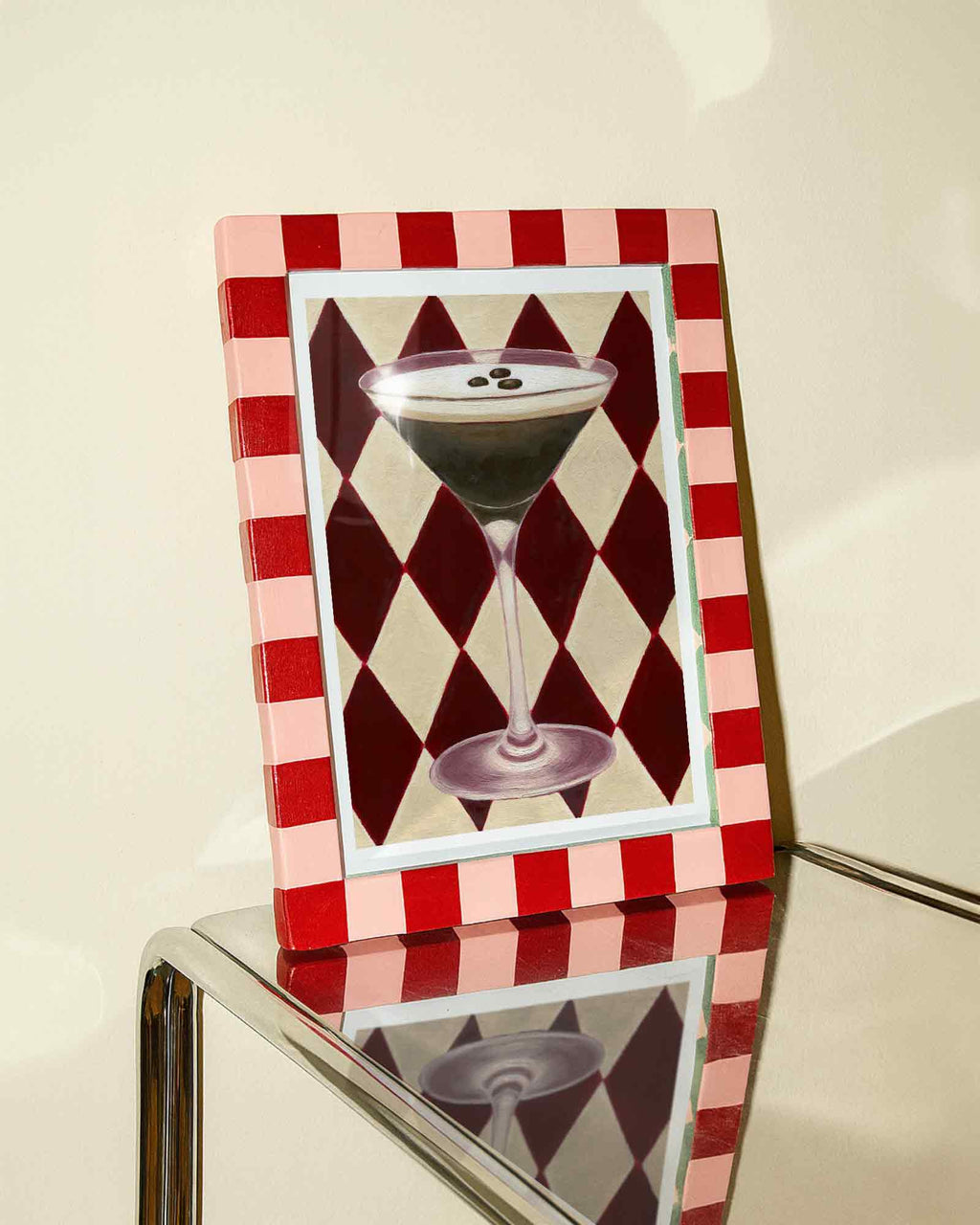 Decorative picture frame with a cocktail illustration on a red and white checkered background