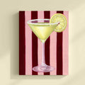 Painting of a martini glass with a lemon slice on a red and pink striped background