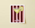 Print of a martini glass with a lemon slice on a red and pink striped background