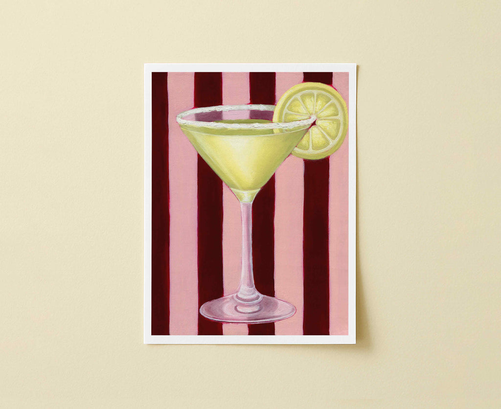Print of a martini glass with a lemon slice on a red and pink striped background