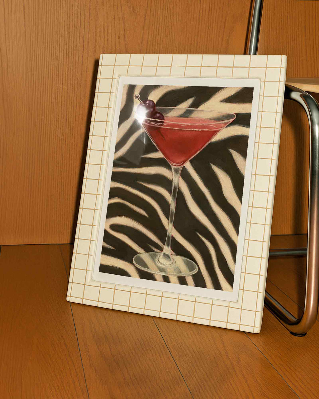 Framed picture of a cocktail with a zebra pattern on a wooden surface