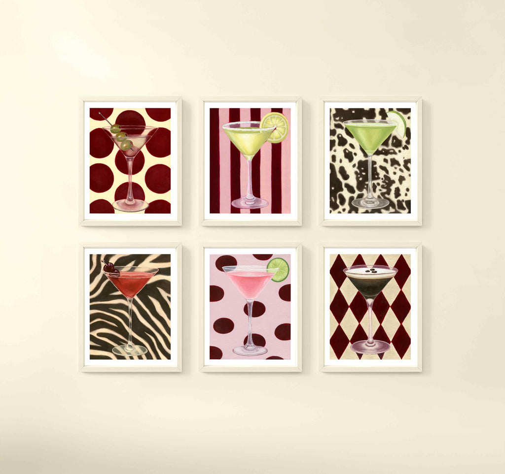 Set of six framed cocktail-themed wall art prints with colorful backgrounds, placed on a beige wall.