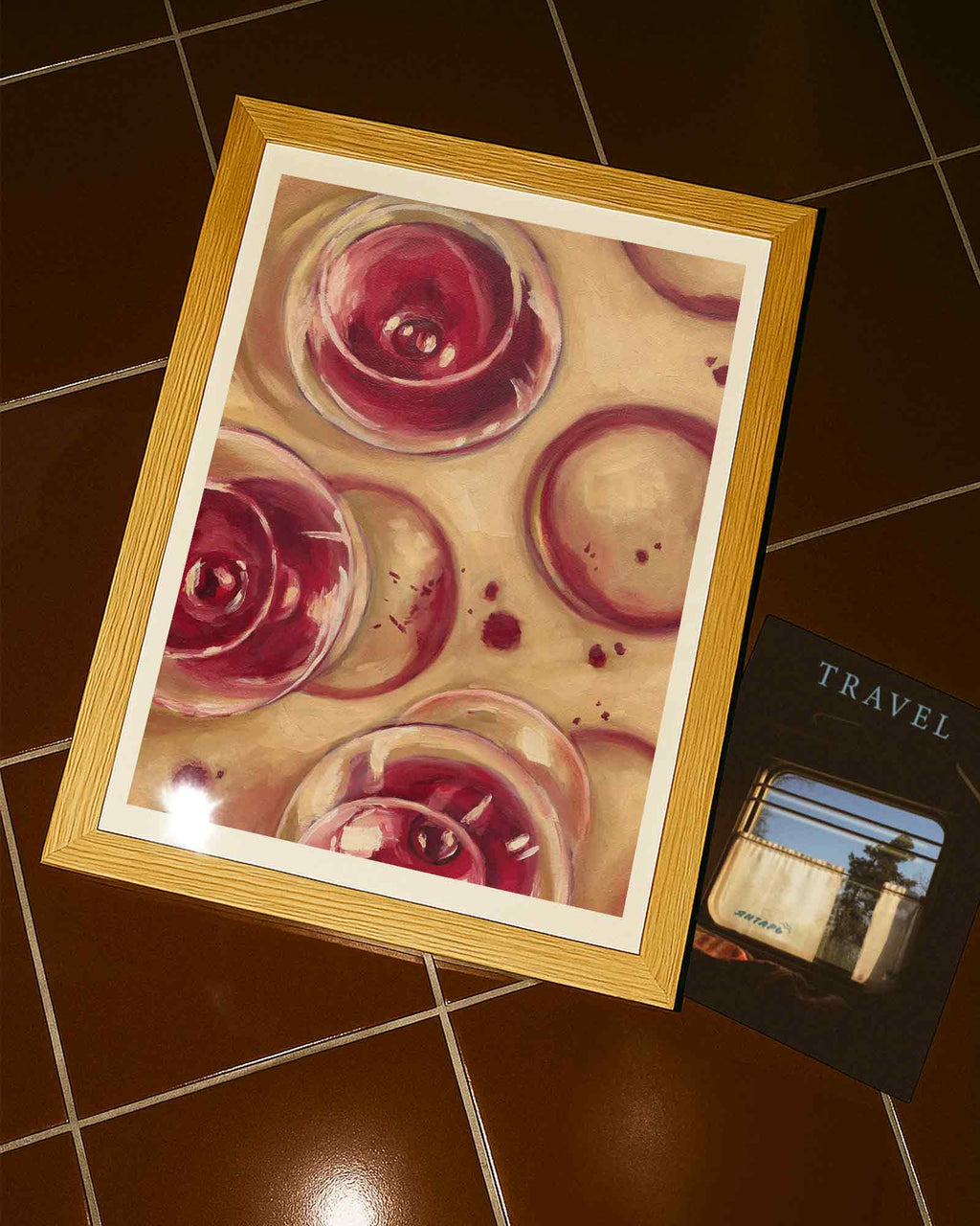 Framed artwork of wine glasses on a tiled floor 